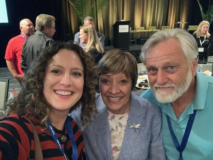 Three community advocates together at a gathering